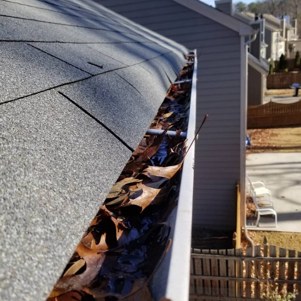 Gutter cleaning and unclog downspouts on a residential home in Cumming, Georgia